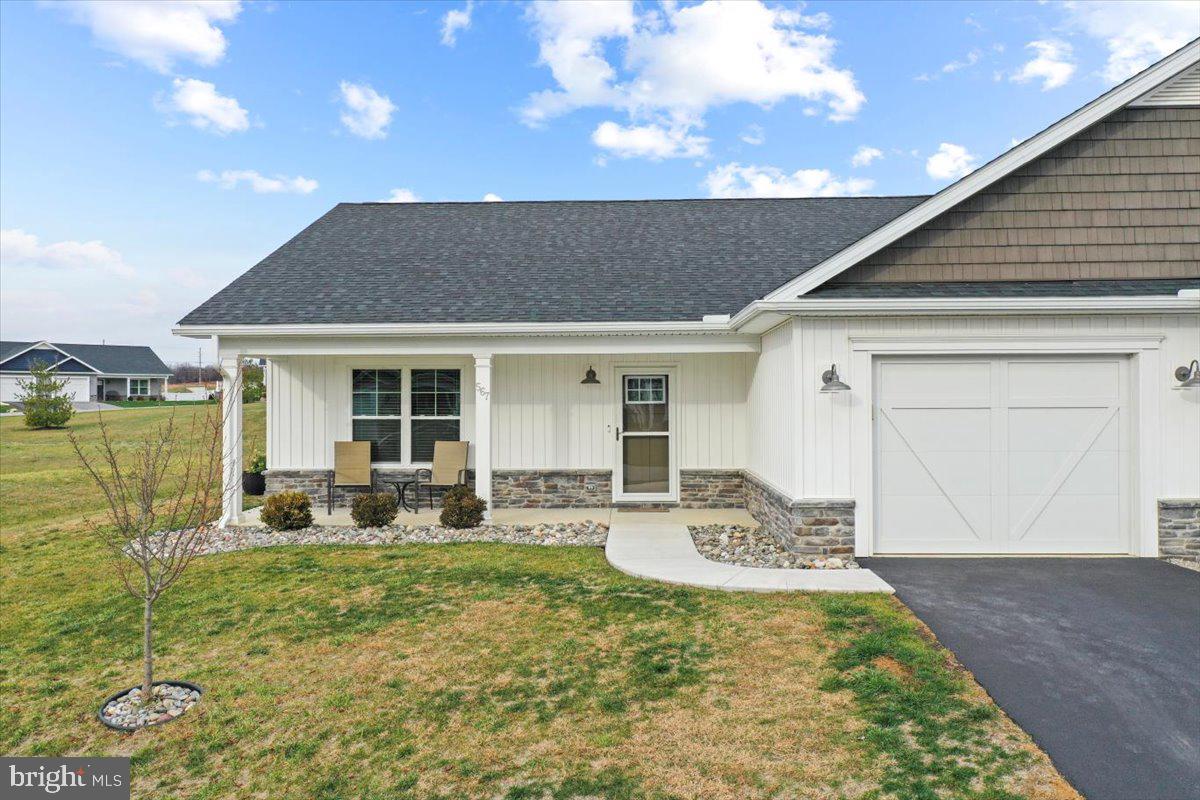 a front view of house with outdoor seating