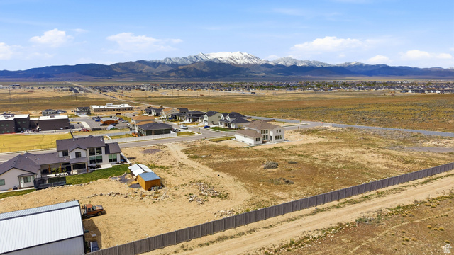 2930 Jojo Road, Unit 110 Eagle Mountain, UT 84005 - Photo 15 of 22 Aerial perspective of suburban area featuring a mountain backdrop