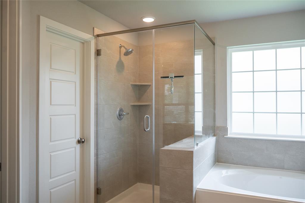 7909 Townsend Drive Waco, TX 76708 - Photo 12 of 22 Walk-in shower with clear glass enclosure and integrated shelving