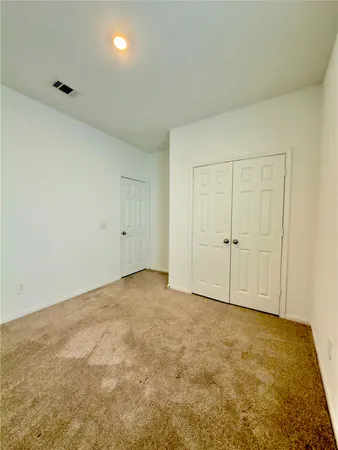a view of an empty room and closet area
