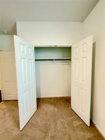 a view of an empty room and closet area