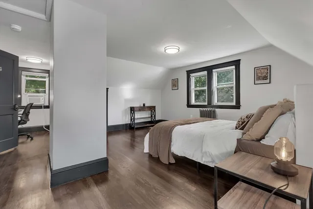 a bedroom with furniture and a window