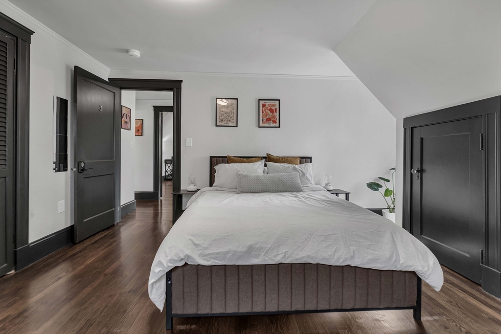 50 Sprague Street Dedham, MA 02026 - Photo 16 of 28 a bedroom with a bed and wooden floor