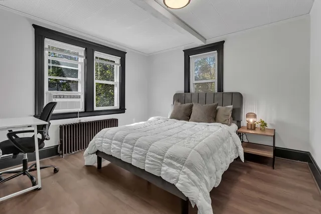 a bedroom with a bed chair and a window