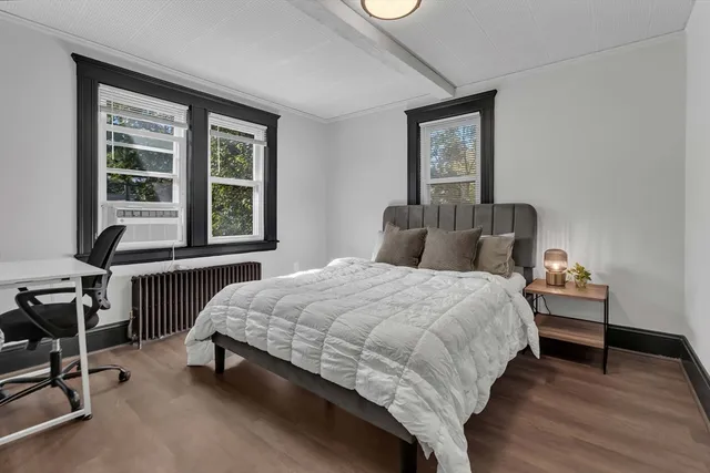 a bedroom with a bed chair and a window