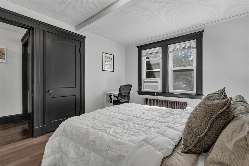 50 Sprague Street Dedham, MA 02026 - Photo 20 of 28 a bedroom with a bed and a large window