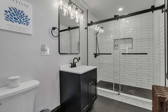 a bathroom with a sink a toilet and shower