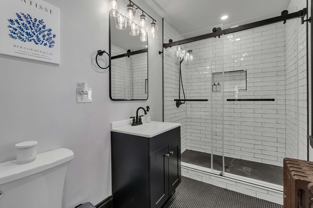 50 Sprague Street Dedham, MA 02026 - Photo 22 of 28 a bathroom with a sink a toilet and shower