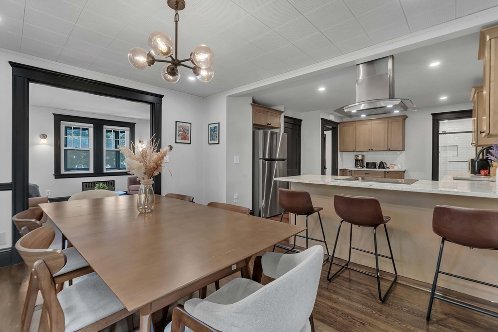 50 Sprague Street Dedham, MA 02026 - Photo 6 of 28 a dining room with kitchen island a table and chairs