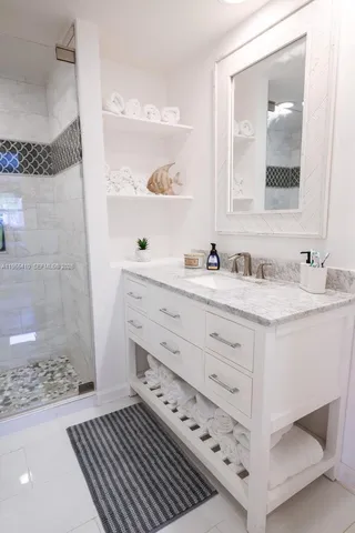 a bathroom with a sink a mirror and a shower