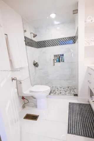 a bathroom with a toilet sink and shower