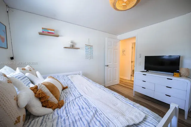 a bedroom with a bed and flat screen tv