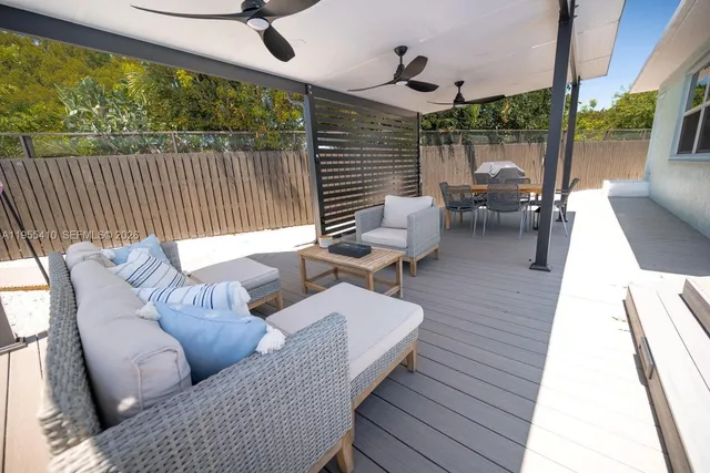 a balcony with furniture and wooden floor