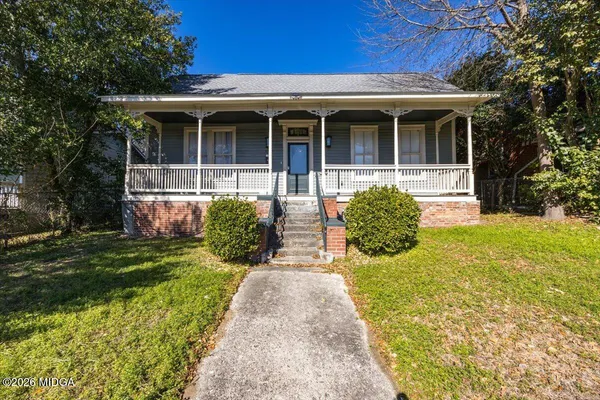 a front view of a house with a yard and porch