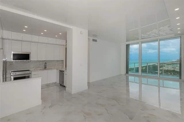 a view of a kitchen with a sink and microwave
