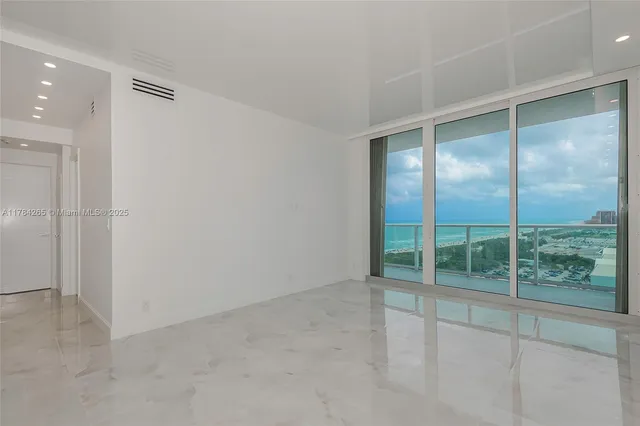 an empty room with sliding glass door