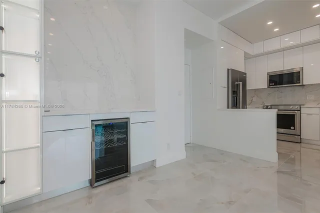 a kitchen with a refrigerator and a sink