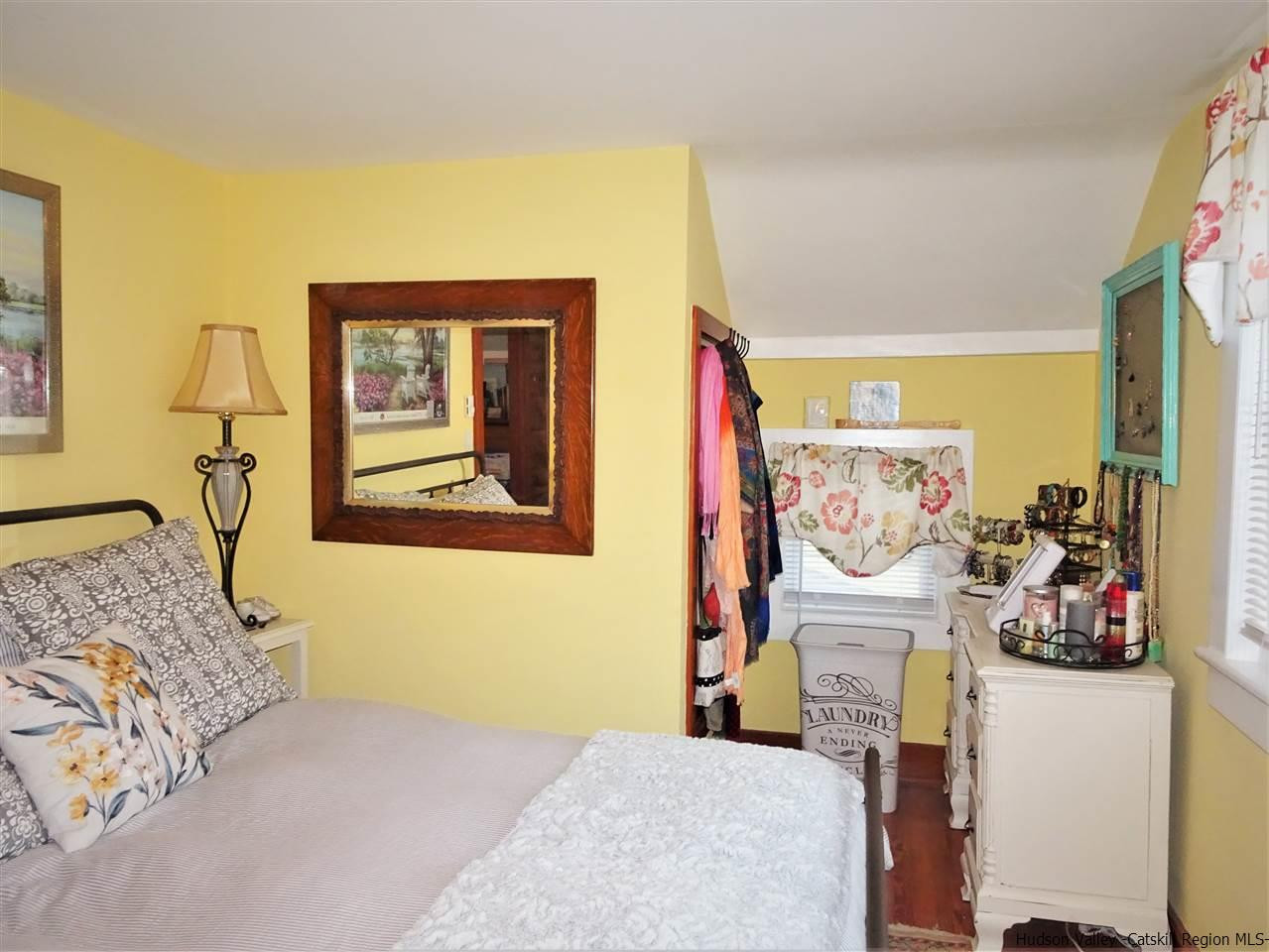 153 Clay Road Ulster Park, NY 12487 - Photo 16 of 25 a bedroom with a bed and a painting on the wall