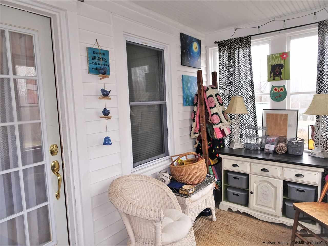 153 Clay Road Ulster Park, NY 12487 - Photo 3 of 25 a room with furniture a flat screen tv and a window