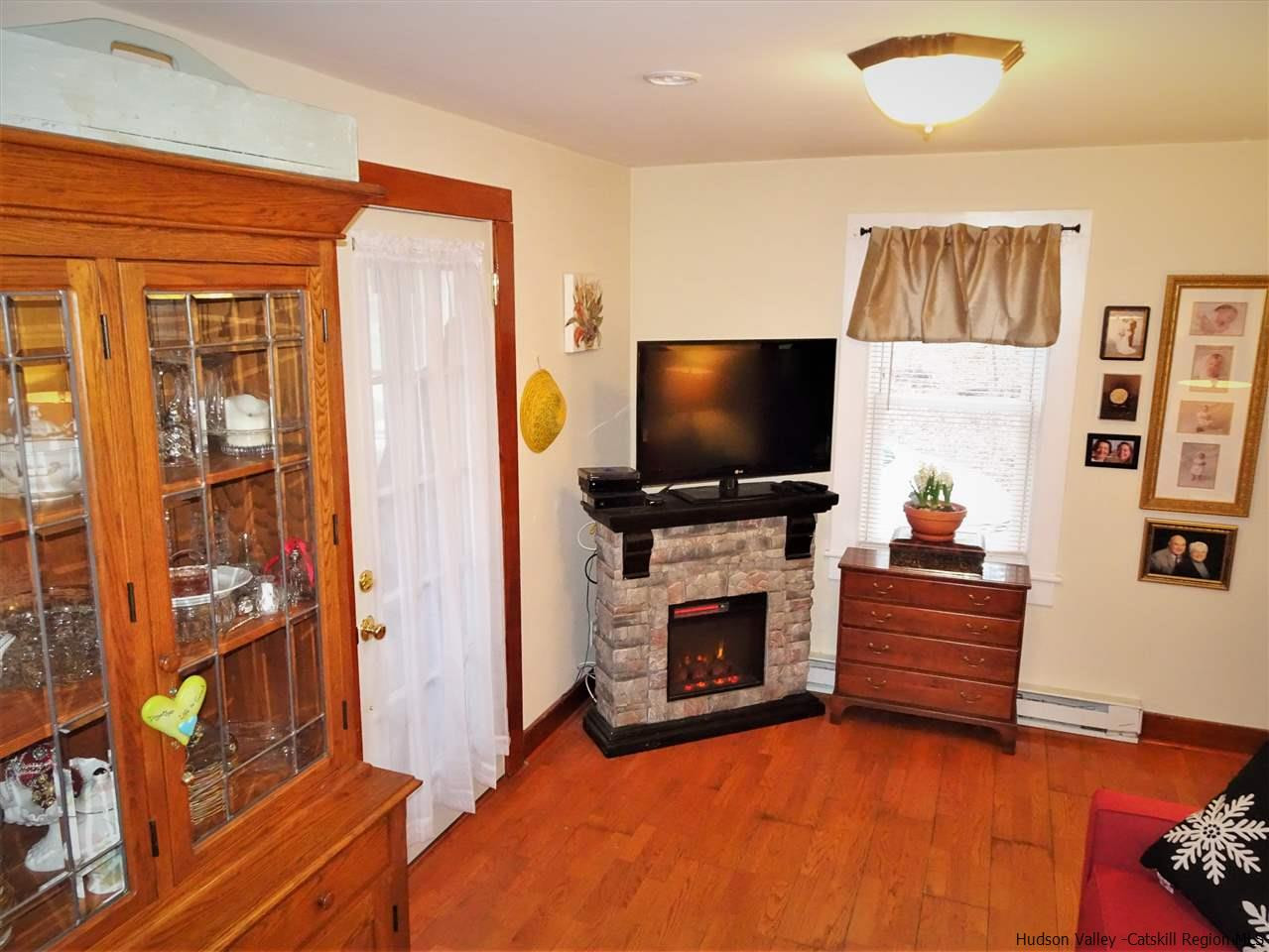153 Clay Road Ulster Park, NY 12487 - Photo 4 of 25 a living room with fireplace furniture and a flat screen tv