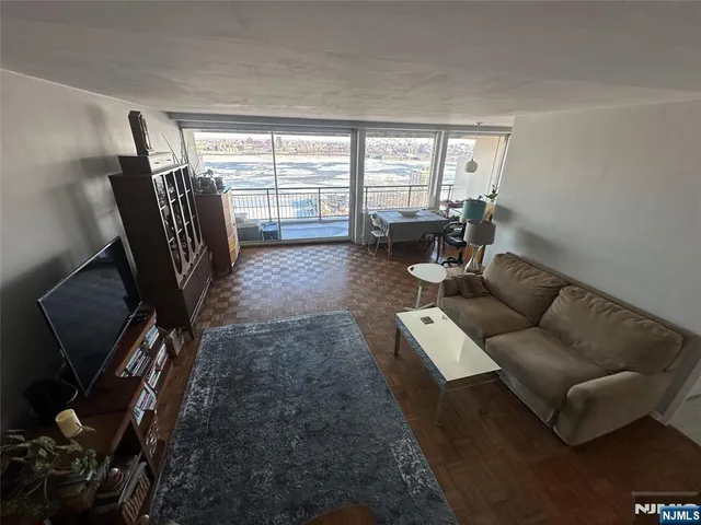 a living room with furniture and a floor to ceiling window