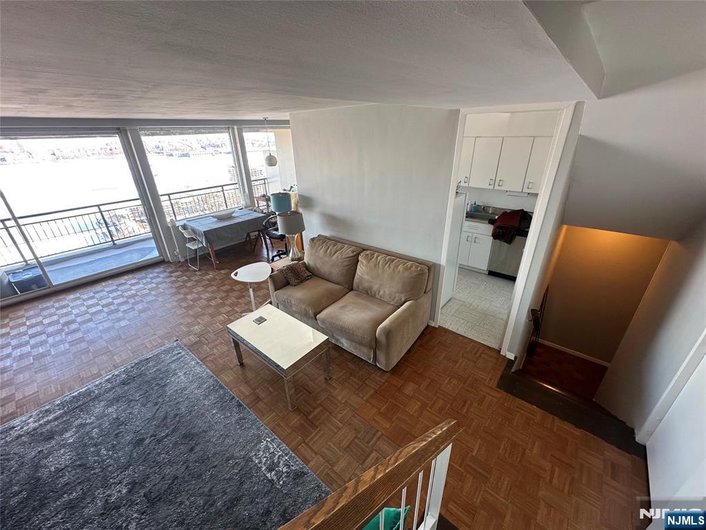 1 Horizon Road, Unit 1025 Fort Lee, NJ 07024 - Photo 19 of 27 a living room with furniture and a large window
