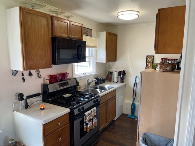 1502 Ridgeway Street Round Lake Beach, IL 60073 - Photo 6 of 11 a kitchen with a stove and a refrigerator