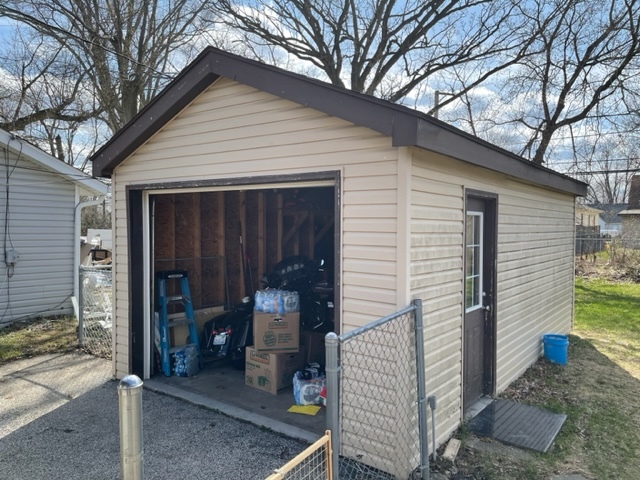 1502 Ridgeway Street Round Lake Beach, IL 60073 - Photo 9 of 11 a view of a house with a yard and garage