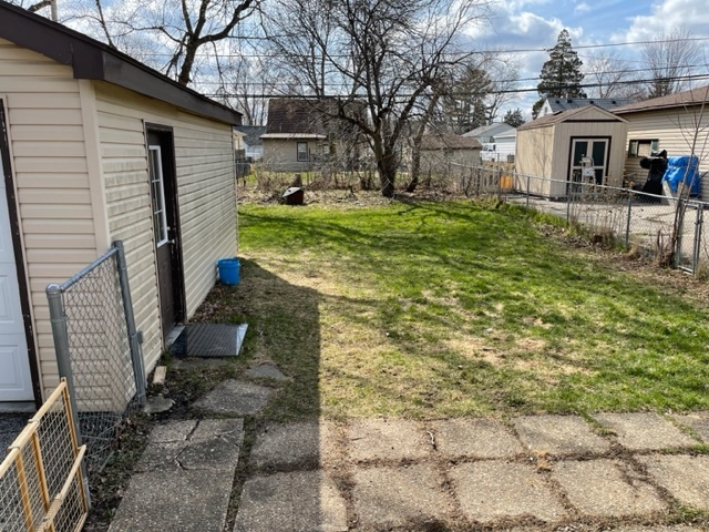 1502 Ridgeway Street Round Lake Beach, IL 60073 - Photo 10 of 11 a front view of a house with garden