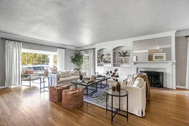 a dining room with furniture and wooden floor