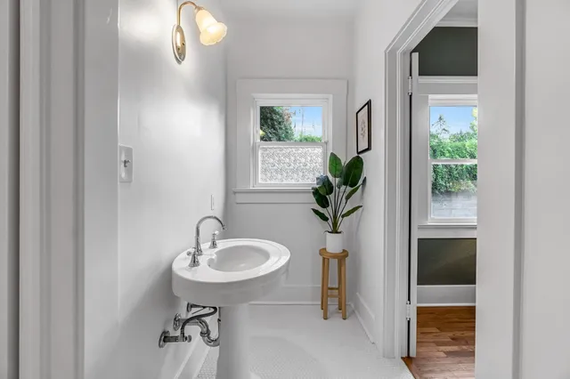a bathroom with a toilet a sink and mirror
