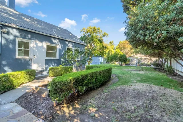 a aerial view of a house with a yard table and chairs