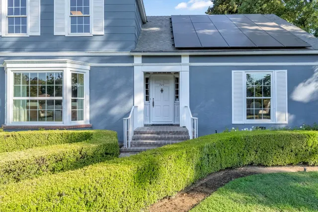 a very nice looking room with wooden floor and a bathroom