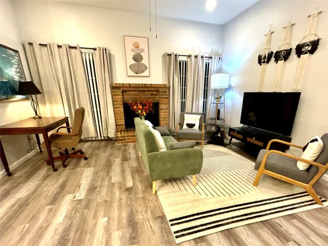 a view of a livingroom with furniture and a flat screen tv