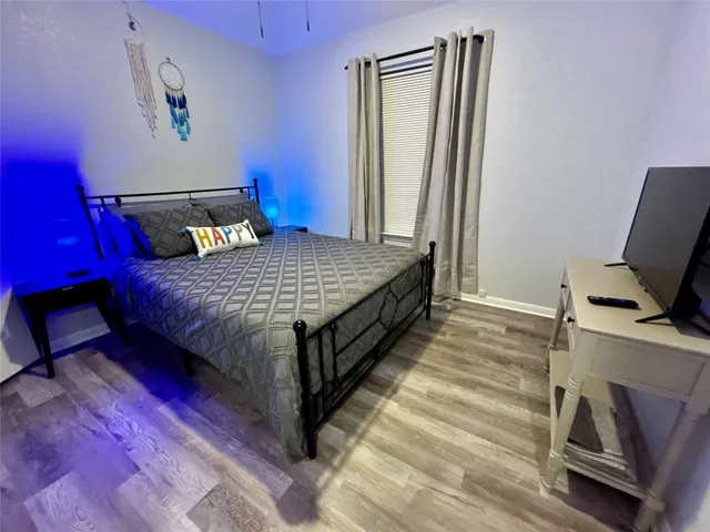 a bedroom with a bed and a flat screen tv