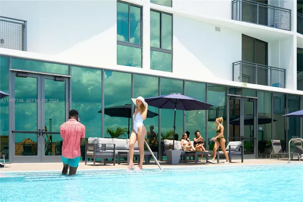 view of living room with furniture and floor to ceiling window