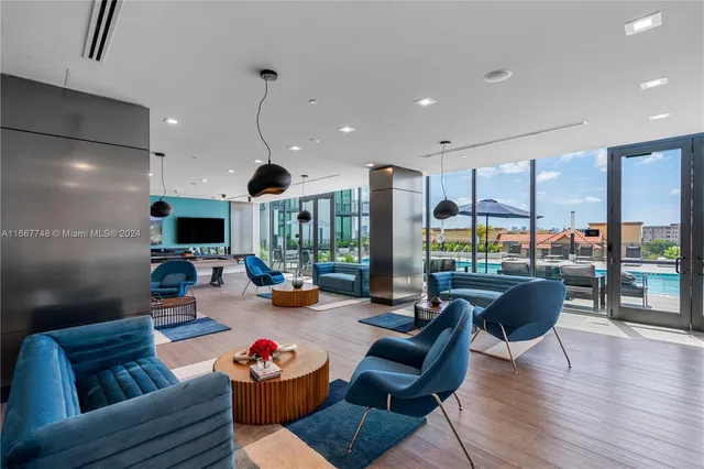 a living room with furniture a rug and a large window