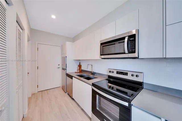 a kitchen with a sink and cabinets