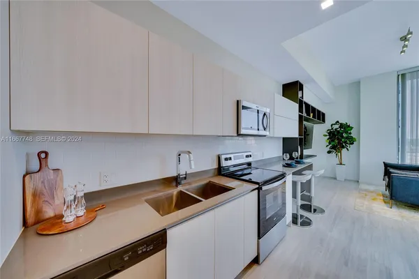 a kitchen that has a sink and a stove