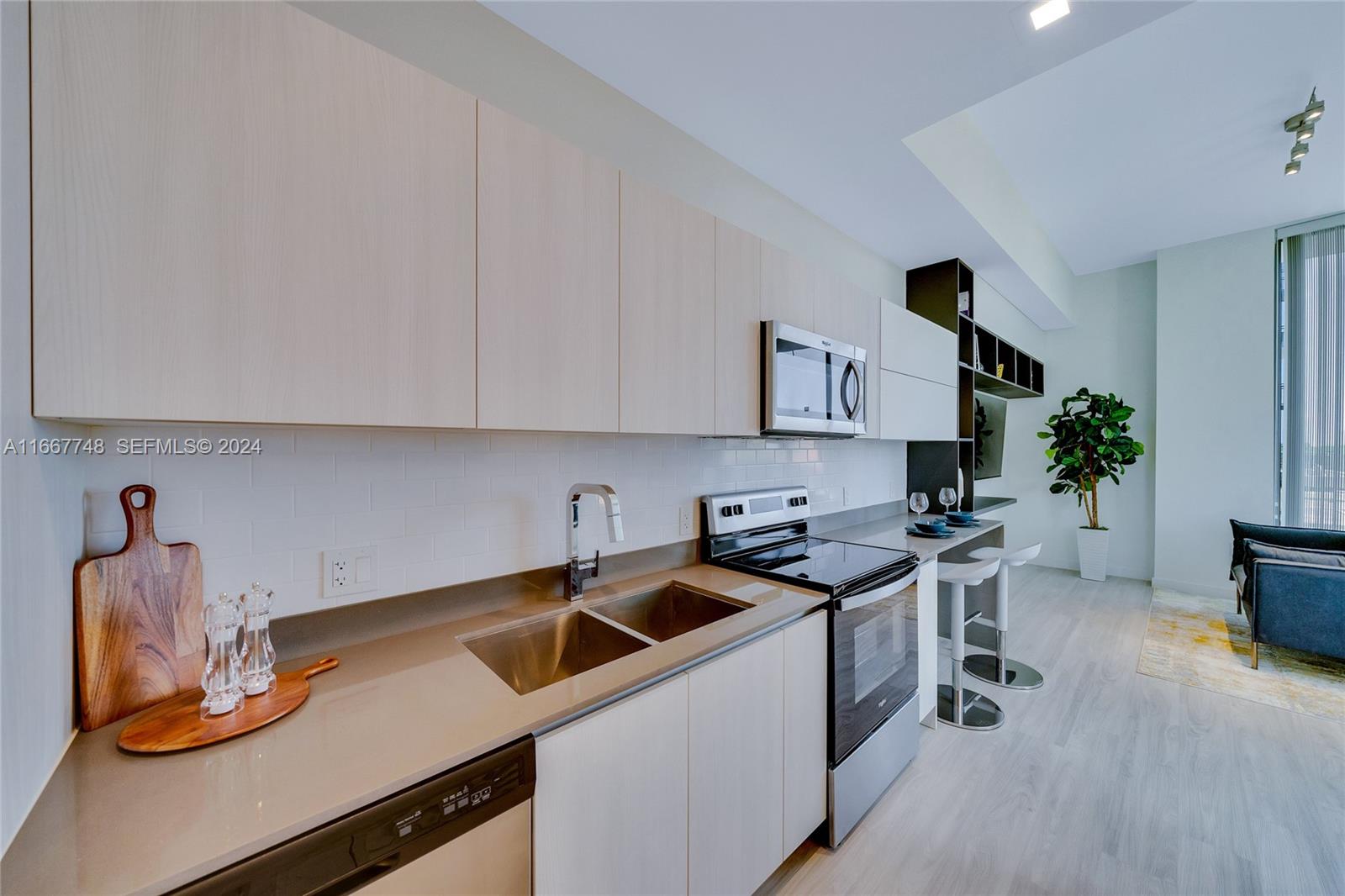 1809 Jackson Street, Unit 1002 Hollywood, FL 33020 - Photo 29 of 46 a kitchen with a sink and cabinets