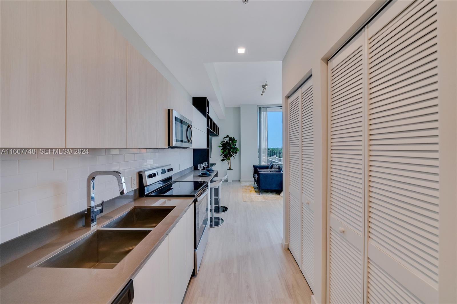 1809 Jackson Street, Unit 1002 Hollywood, FL 33020 - Photo 31 of 46 a kitchen that has a sink and a stove