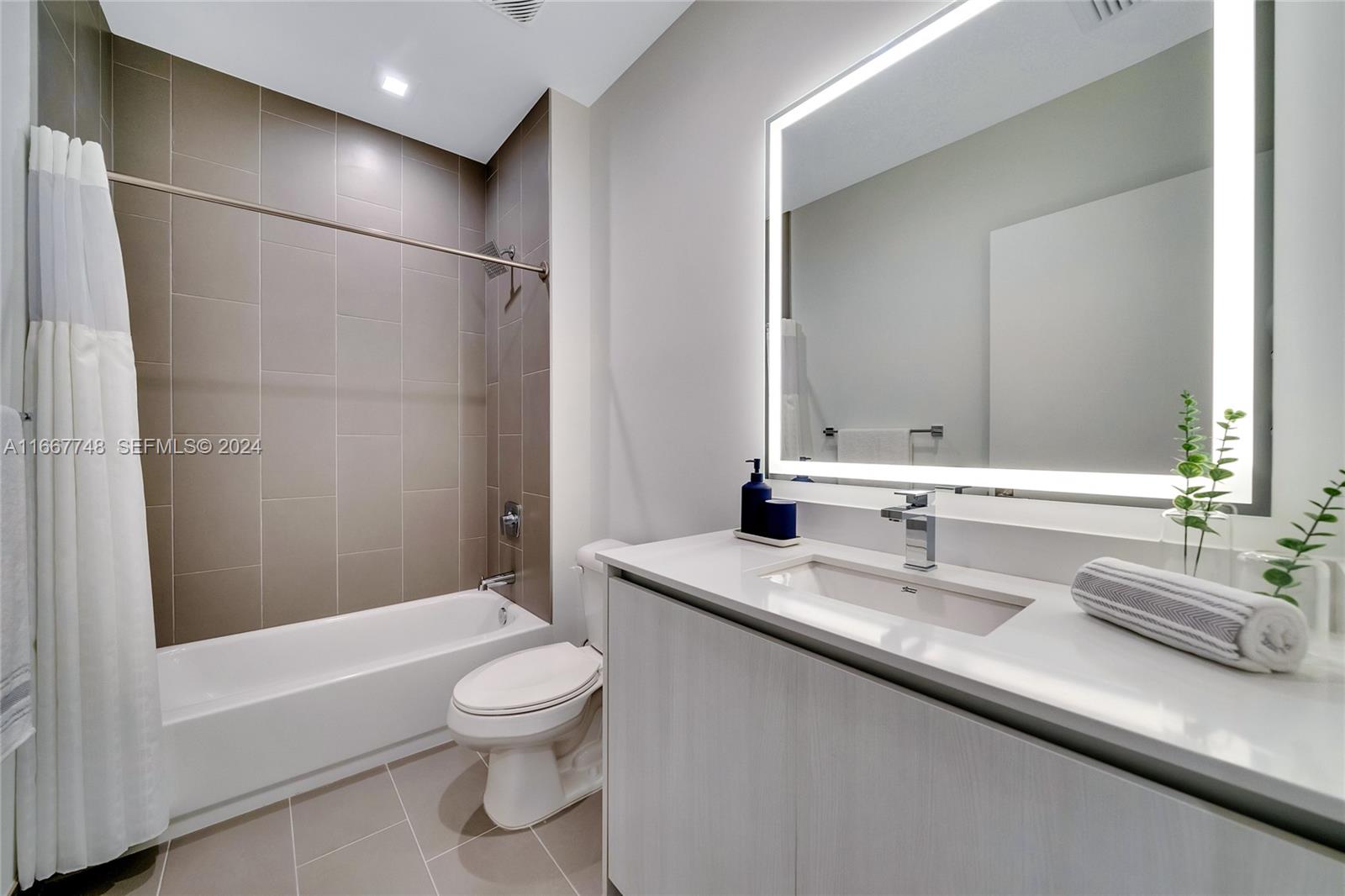 1809 Jackson Street, Unit 1002 Hollywood, FL 33020 - Photo 33 of 46 a bathroom with a granite countertop sink toilet and shower