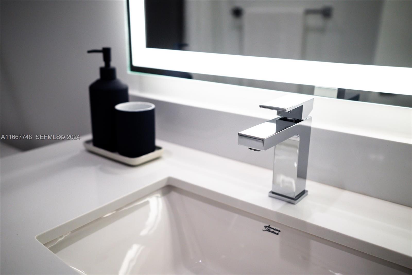 1809 Jackson Street, Unit 1002 Hollywood, FL 33020 - Photo 34 of 46 a kitchen with a sink and a mirror