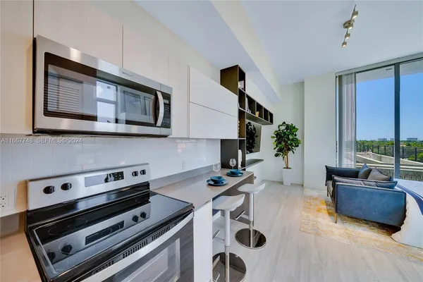 a kitchen that has a sink and cabinets