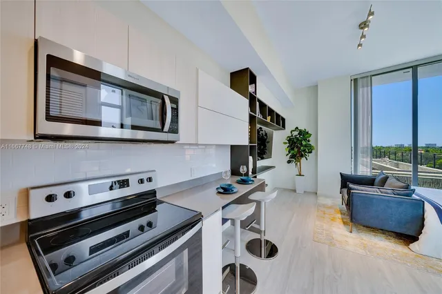 a kitchen that has a sink and cabinets