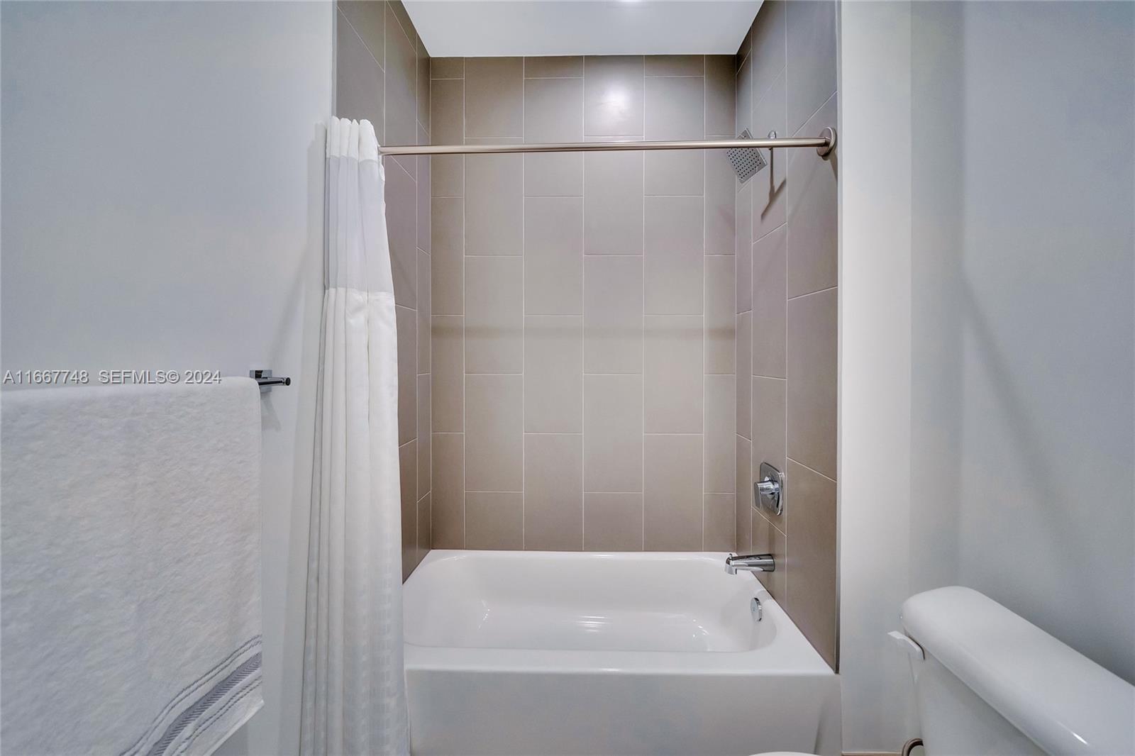 1809 Jackson Street, Unit 1002 Hollywood, FL 33020 - Photo 36 of 46 a bathroom with a bathtub and a toilet