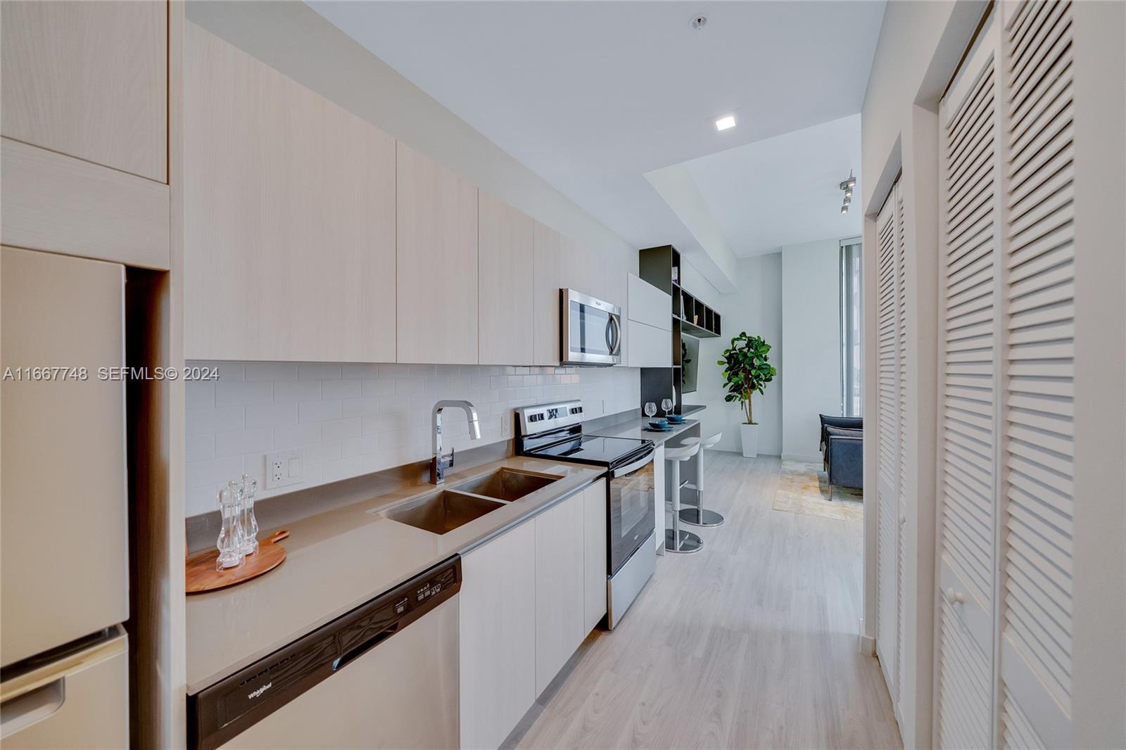1809 Jackson Street, Unit 1002 Hollywood, FL 33020 - Photo 37 of 46 a kitchen that has a sink and cabinets