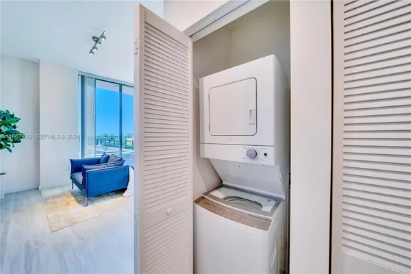 a living room with furniture cabinets and a potted plant