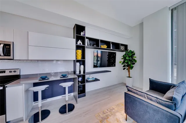 a kitchen with a sink appliances and cabinets