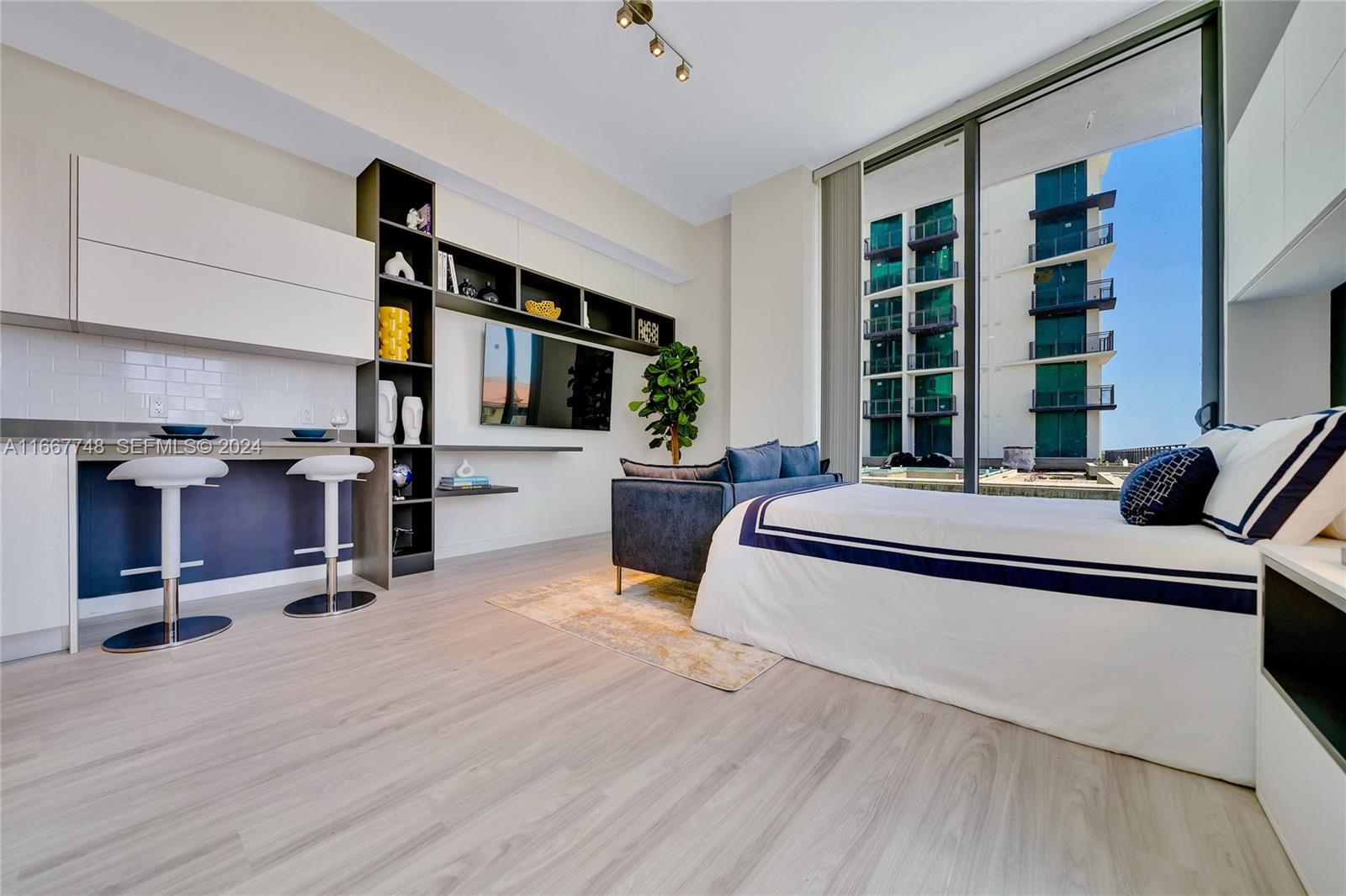 1809 Jackson Street, Unit 1002 Hollywood, FL 33020 - Photo 45 of 46 a bed room with a bed and a desk